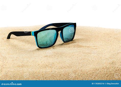 Sunglasses With Blue Glasses On The Sand In The Desert Isolated Stock