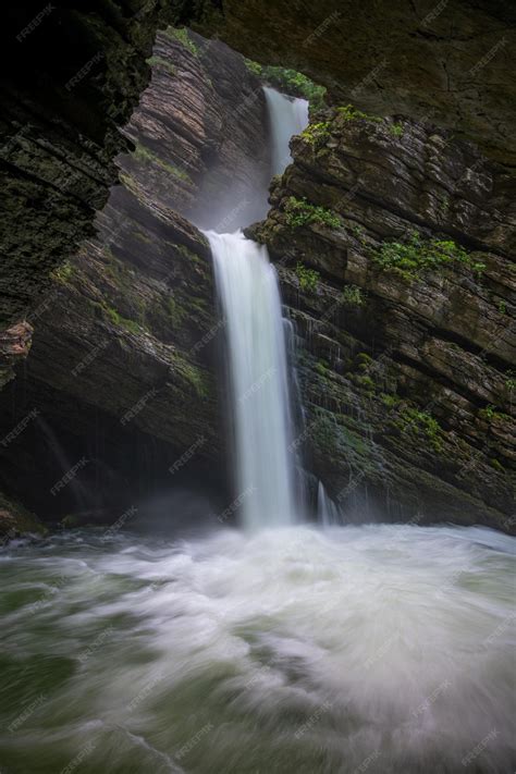 Premium Photo | A mystical waterfall flowing from a cave