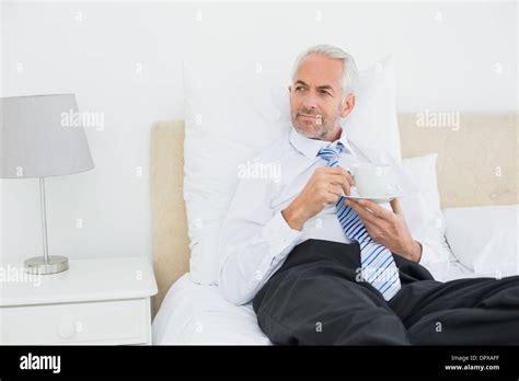 Well Dressed Mature Man With A Cup Of Tea In Bed Stock Photo Alamy