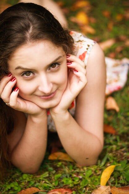 Premium Photo Portrait Of Woman Lying On Grass