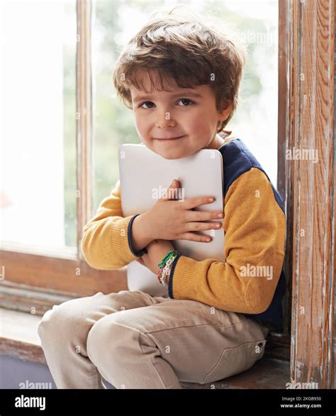 Hes Tech Savvy Already A Cute Little Boy Using A Tablet While Sitting