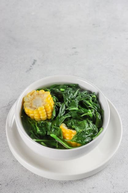 Premium Photo | Sayur bening bayam or spinach clear soup with corn