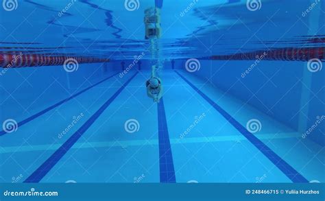 Sportswoman Swimmer In A Tracksuit In Diving Goggles In A Swimming