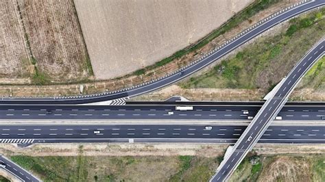 Premium Photo Aerial View Of Asphalt Road With The Rural Area On Both