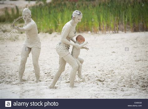 People Enjoy Hot Weather And Bathe In The Mud Pool With Kaolin In Quarry In Village Jimlikov