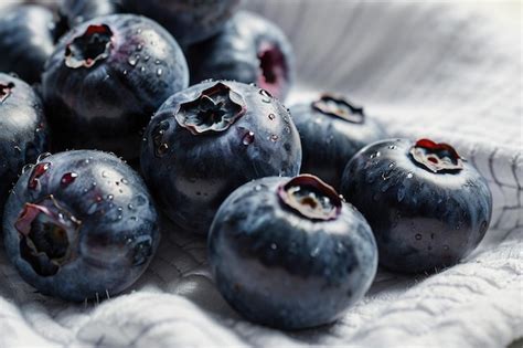 Blueberries On A White Kitchen Towel Premium Ai Generated Image