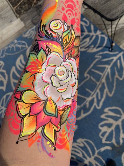 A Woman S Arm With Flowers Painted On It