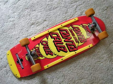 A Red Skateboard With Yellow Wheels Laying On The Floor Next To A White