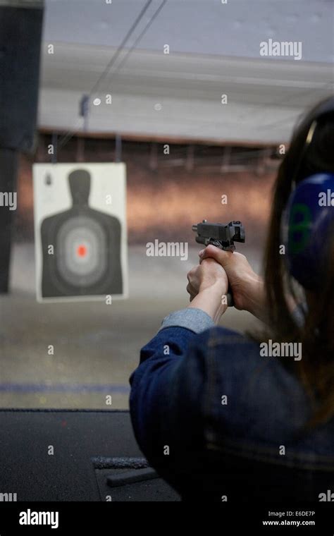 Young Woman Shooting A Handgun At A Shooting Range In Minneapolis Usa
