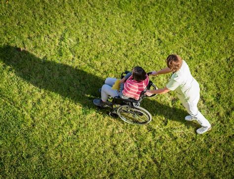 Premium Photo Elderly Woman In Wheelchair Top View On Grass With