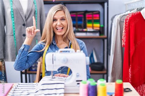 Blonde Woman Dressmaker Designer Using Sew Machine Smiling Amazed And