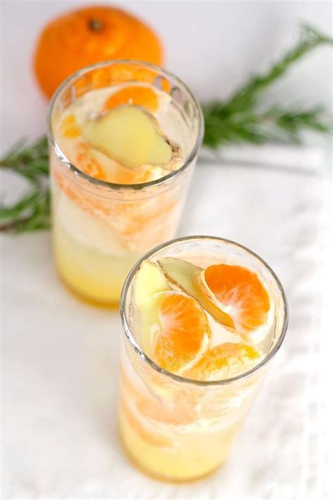 Two Glasses Filled With Orange Juice And Garnish