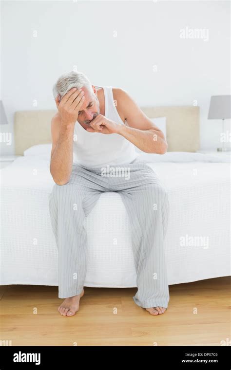 Thoughtful Mature Man Yawning In Bed Stock Photo Alamy