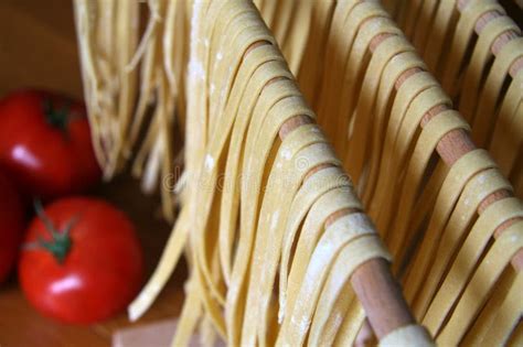 Handmade Fresh Pasta And Tomatoes Drying On Wooden Rack Italy