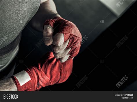 Closeup Male Hand Of Boxer With Red Boxing Bandages Fists Of Fighter