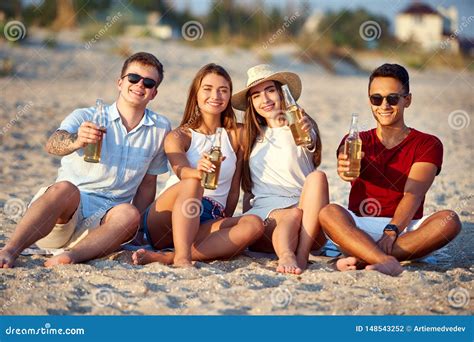 Group Of Friends Having Fun Enjoying A Beverage And Relaxing On The