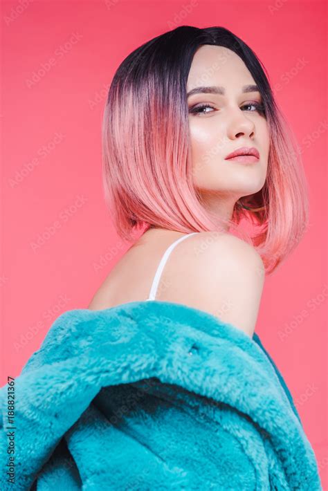 Sensual Girl With Pink Hair Posing In Blue Fur Coat Isolated On Pink