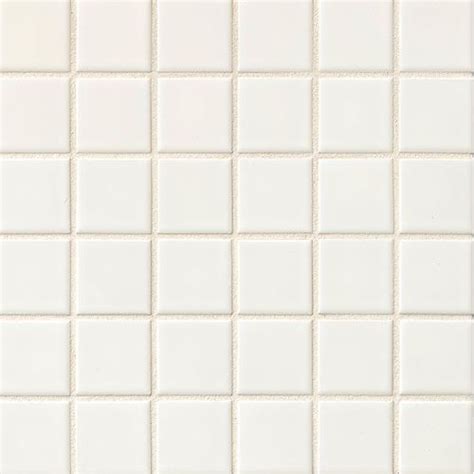 A White Tiled Wall With Small Squares On It