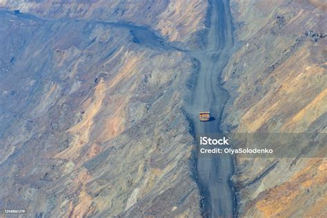 Huge Yellow Mining Dump Truck Working In Iron Ore Quarry Mining