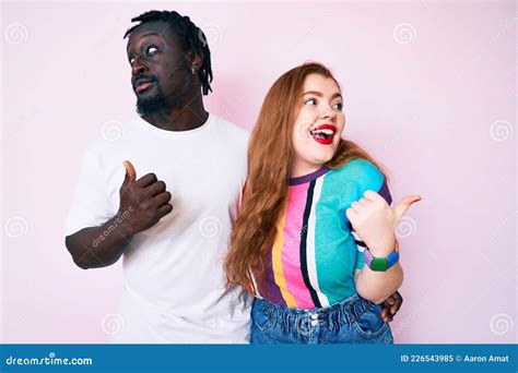 Interracial Couple Wearing Casual Clothes Smiling With Happy Face