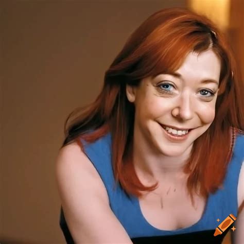 Alyson Hannigan Sitting On A Bed In A Hotel Wearing A Striped Sweater