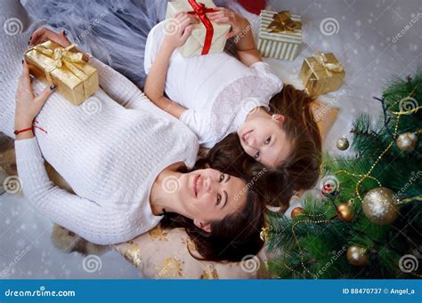 Mother And Daughter Lying Under Christmas Tree Stock Image Image Of