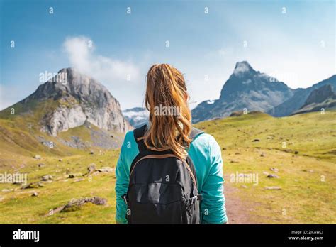 Young Attractive Woman With A Backpack Hiking In A Beautiful Valley