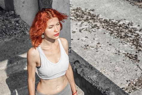 Premium Photo Woman In Running Gear Crop Top And Shorts Stretching