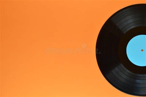 Half Black Vinyl Record On Orange Background Stock Image Image Of