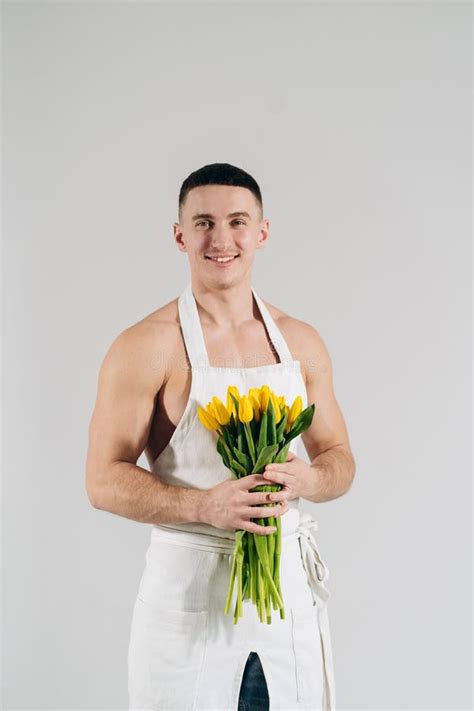 Man Man With Naked Torso In Apron Gives Flowers Romantic Man With