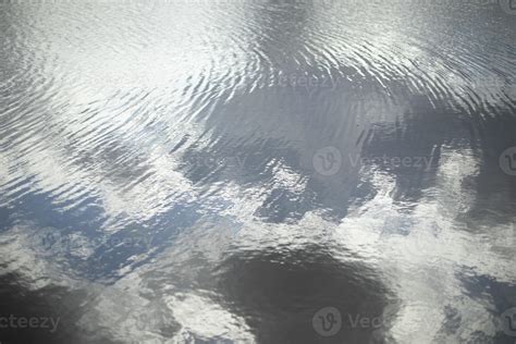 Texture Of Water Reflection Of Clouds In Water Ripples On Lake