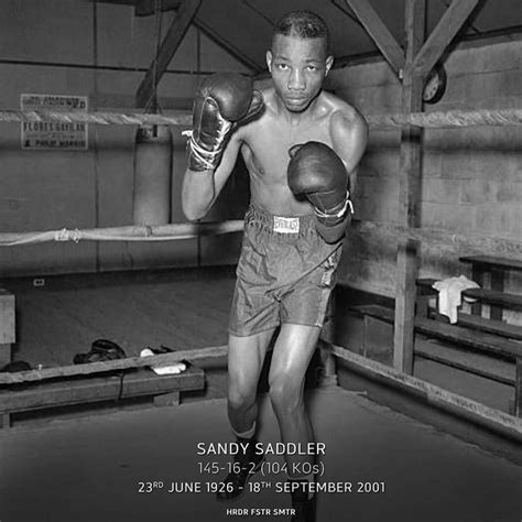 a black and white photo of a man wearing boxing gloves