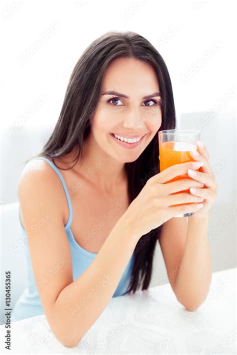 Young Beautiful Woman Holding Glass Of Orange Juice Stock Foto Adobe