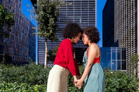 Premium Photo Lesbian Couple Holding Hands Standing Against Building