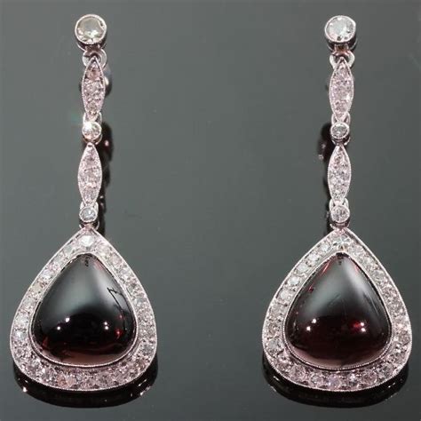 Long Hanging Platinum Earrings With Diamonds And Cabochon Garnets