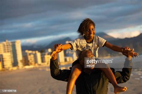 27 Black Father Carrying Daughter On Shoulders At Beach Stock Photos