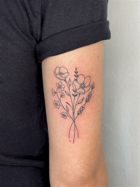 A Woman With A Flower Tattoo On Her Arm