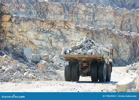 Huge Dump Truck Transporting Granite Rock Or Iron Ore Stock Photo