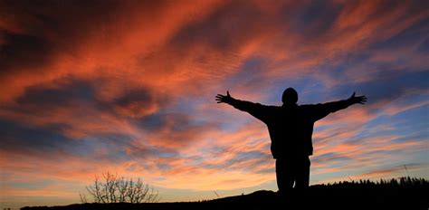 Unrecognizable Man With Arms Outstretched In Worship Stock Photo