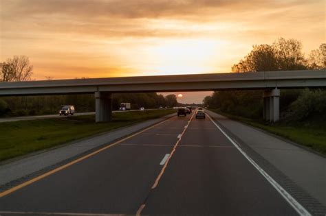 Premium Photo | A highway with a sunset in the background