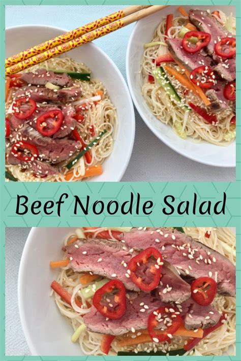 Beef Noodle Salad In Two White Bowls With Chopsticks On The Side And