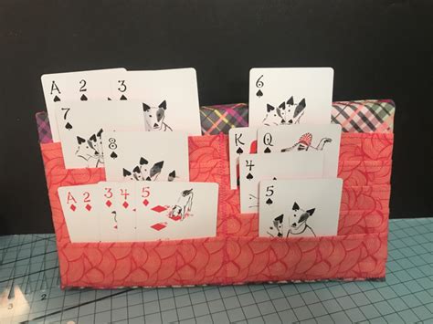 Playing Cards Are Placed On Top Of Each Other To Make A Card Holder For