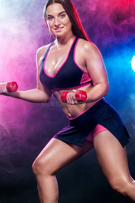 Fitness Woman Athlete And Bodybuilder Holding Dumbbell On Black