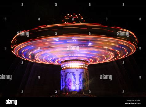 Blue And Red Spinning Carousel At Night In The Uk Stock Photo Alamy