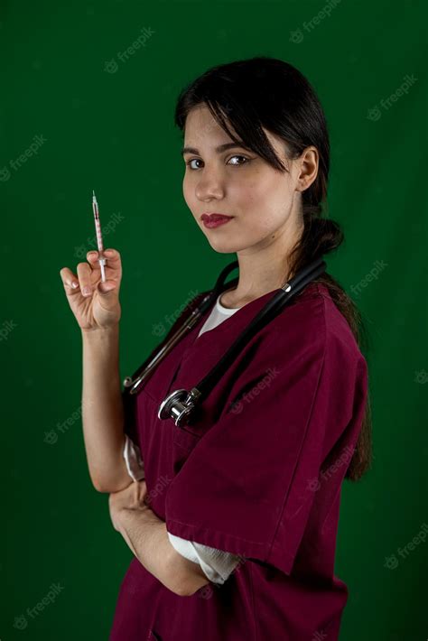 Premium Photo Nurse In Protective Overalls Holding Vaccine And