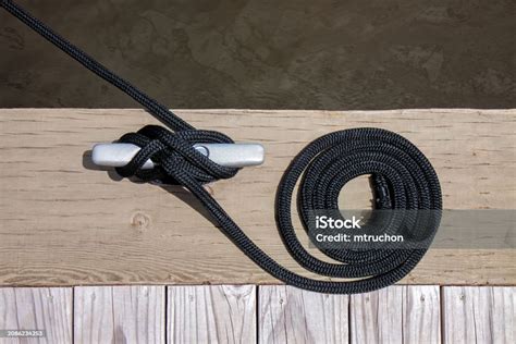 Black Mooring Rope Knotted To A Sliver Cleat Stock Photo Download