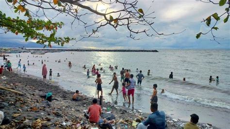 Potret Warga Manado Nikmati Mandi Di Pantai Penuh Sampah Plastik