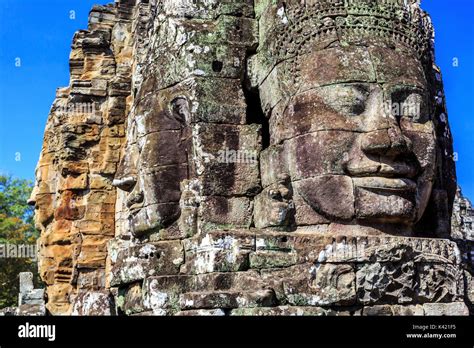 Giant Stone Faces Of Ancient Buddhist Khmer Bayon Temple In Angkor Thom