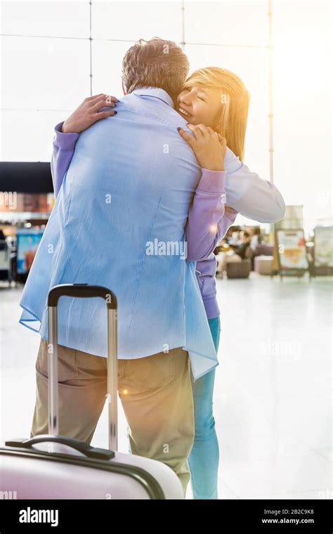 Portrait Of Mature Man Reuniting With His Daughter In Airport Stock