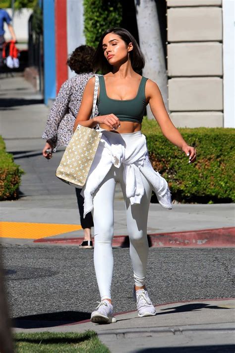 Olivia Culpo Looks Flawless In A Green Crop Top And White Leggings While Leaving A Hair Salon In